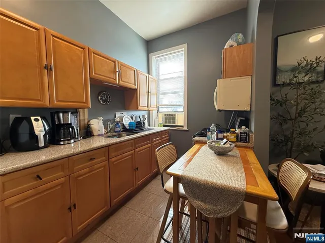 a kitchen with sink and a refrigerator