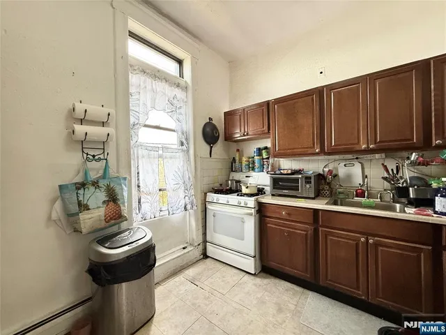 a kitchen with a sink cabinets and window