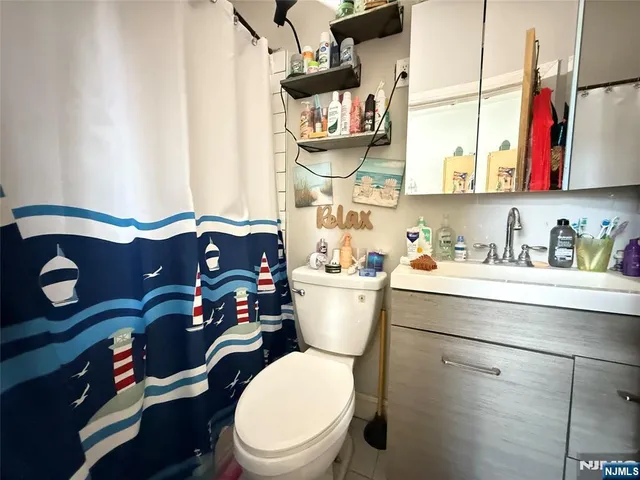 a bathroom with a sink toilet and mirror