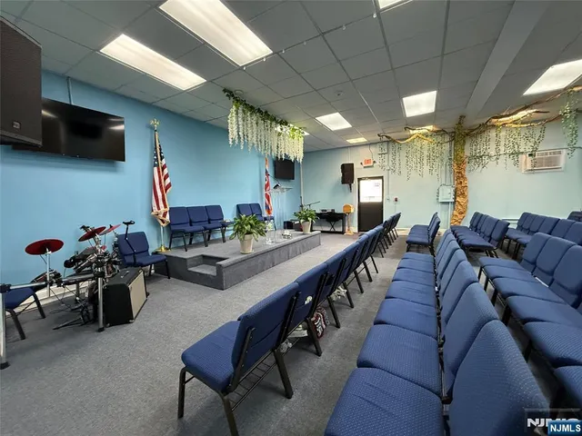 a living room with furniture a flat screen tv and a chandelier