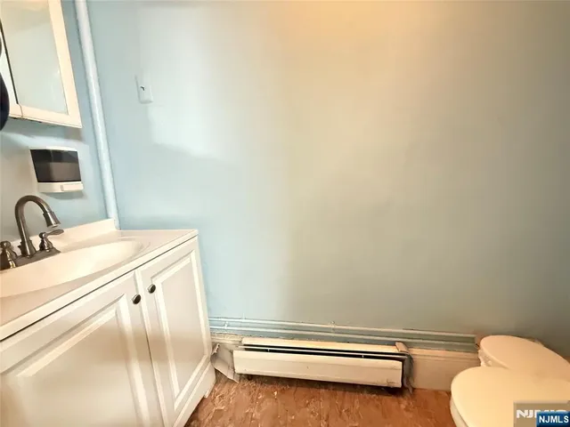 a bathroom with a sink a toilet and mirror