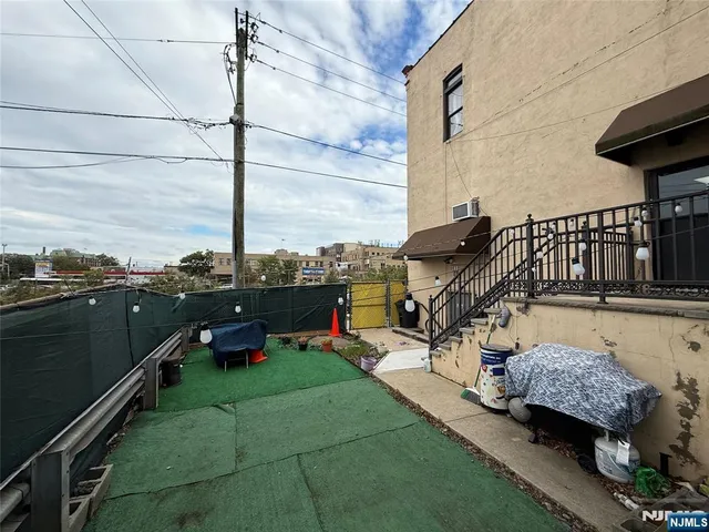 a backyard of a house with table and chairs