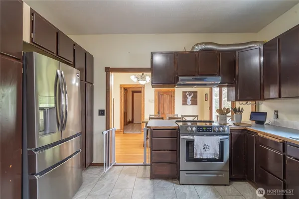 a kitchen with stainless steel appliances granite countertop a refrigerator and a sink