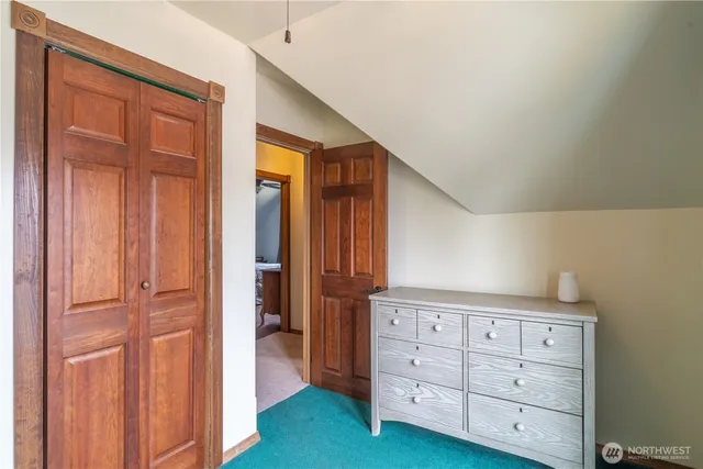 a bedroom with a bed and a dresser