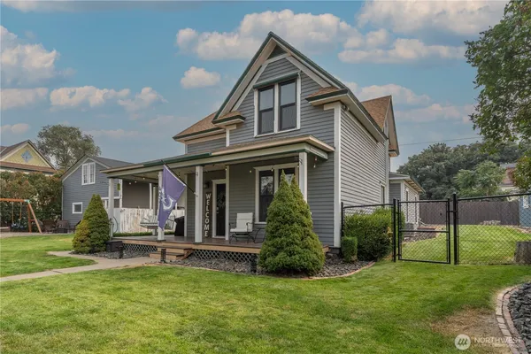 a view of a house with a yard porch and sitting area