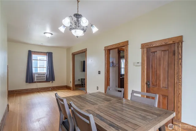 a view of a dining room with furniture and wooden floor