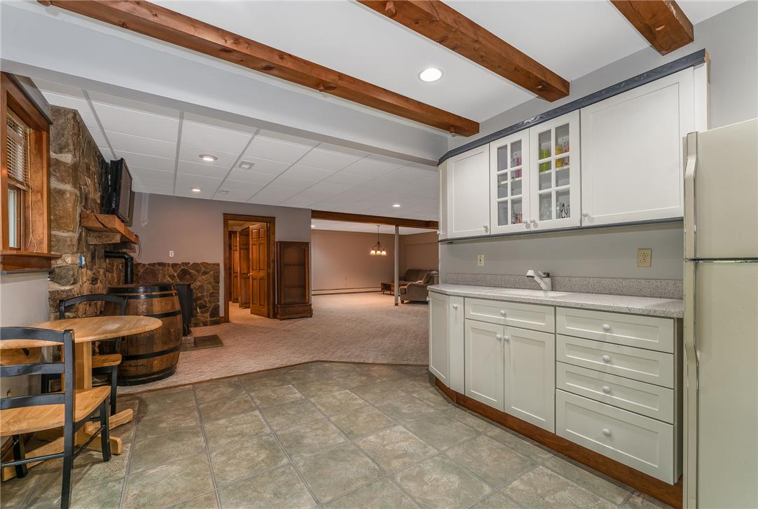 465 Raubsville Road Easton, PA 18042 - Photo 51 of 60 Entertaining options abound in this versatile basement with a wet bar, inviting fireplace, and additional living space.
