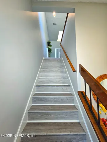 a kitchen with a sink microwave and cabinets