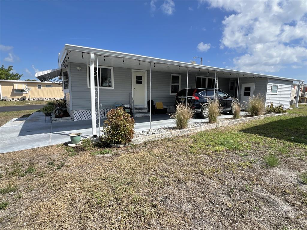 7181 Mt Hawthorne Road Northeast, Unit 590 St. Petersburg, FL 33702 - Photo 1 of 16 a front view of a house with garden and patio