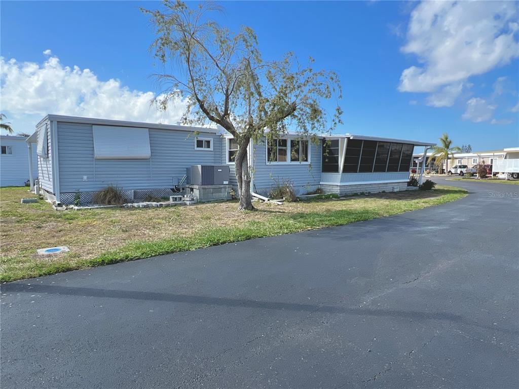 7181 Mt Hawthorne Road Northeast, Unit 590 St. Petersburg, FL 33702 - Photo 15 of 16 a view of a house with a big yard