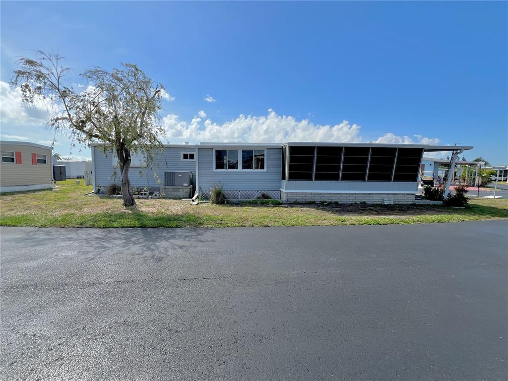 7181 Mt Hawthorne Road Northeast, Unit 590 St. Petersburg, FL 33702 - Photo 16 of 16 a front view of house with yard and green space