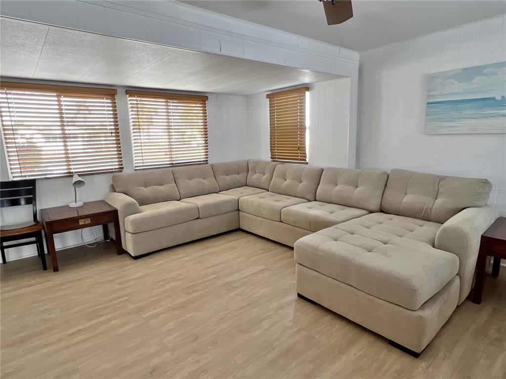 7181 Mt Hawthorne Road Northeast, Unit 590 St. Petersburg, FL 33702 - Photo 3 of 16 a living room with furniture and a large window