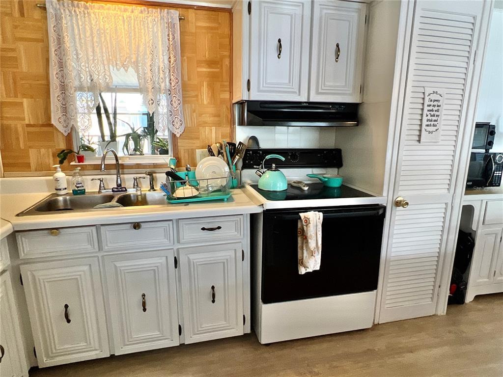 7181 Mt Hawthorne Road Northeast, Unit 590 St. Petersburg, FL 33702 - Photo 5 of 16 a kitchen with stainless steel appliances granite countertop white cabinets and a sink