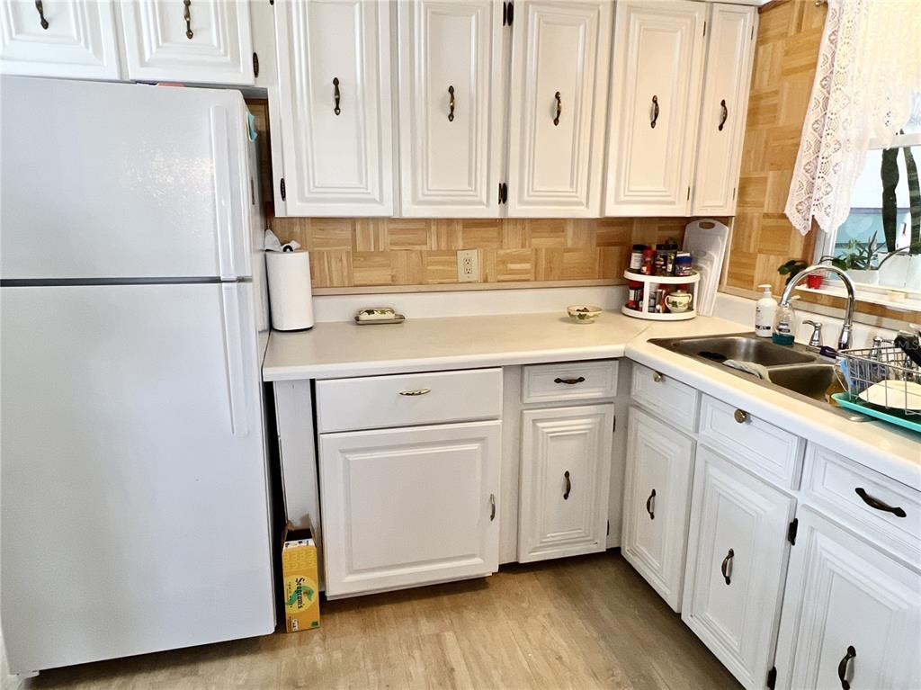 7181 Mt Hawthorne Road Northeast, Unit 590 St. Petersburg, FL 33702 - Photo 6 of 16 a kitchen with stainless steel appliances white cabinets and a sink