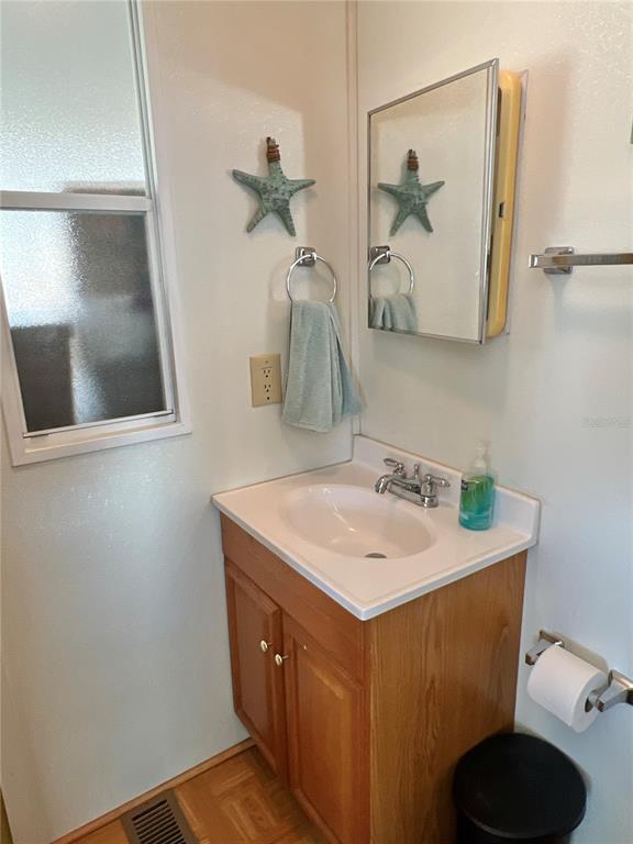 7181 Mt Hawthorne Road Northeast, Unit 590 St. Petersburg, FL 33702 - Photo 9 of 16 a bathroom with a sink and a mirror