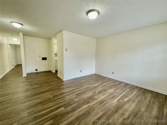 a view of a room with wooden floor and window