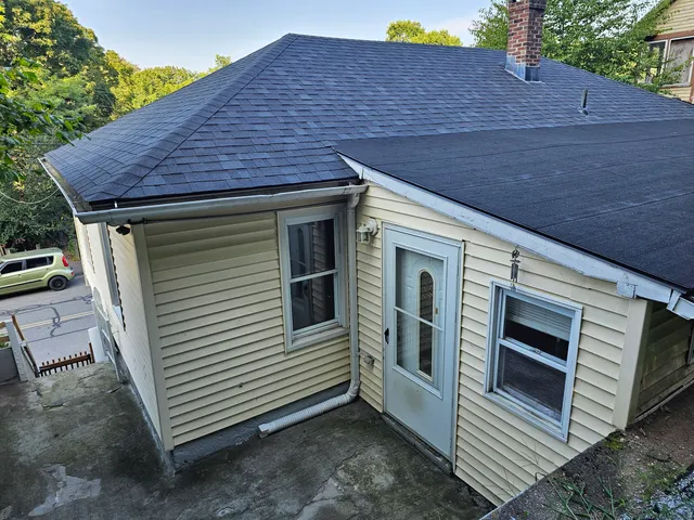 a view of a small house and a yard