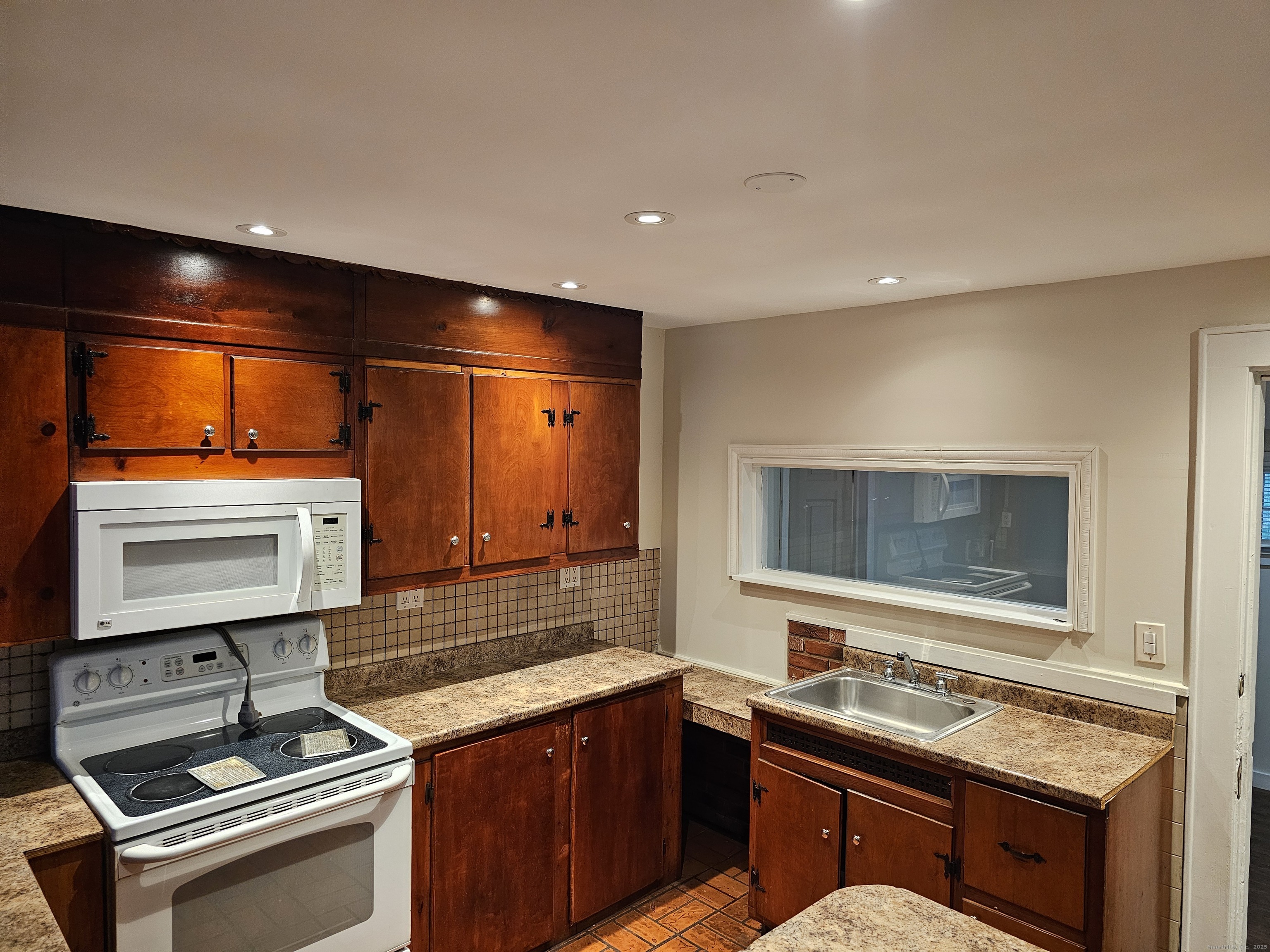 68 New Street Seymour, CT 06483 - Photo 13 of 18 a kitchen with a sink stove and microwave