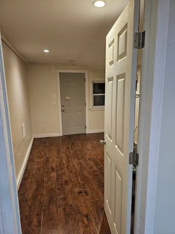 a view of a hallway with a bathroom