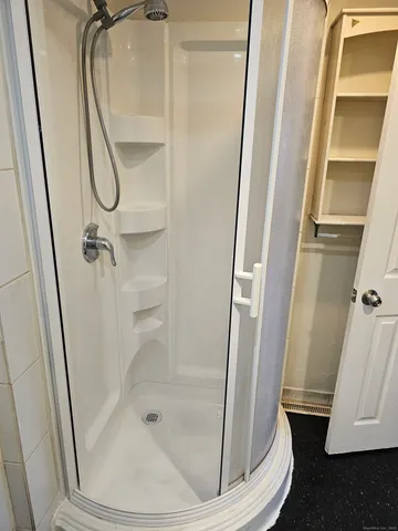 a bathroom with a glass shower door