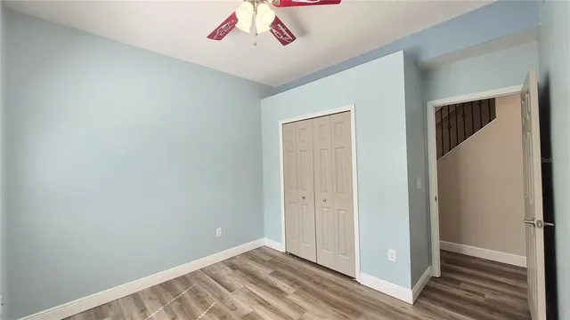 an aerial view of residential houses with outdoor space and trees
