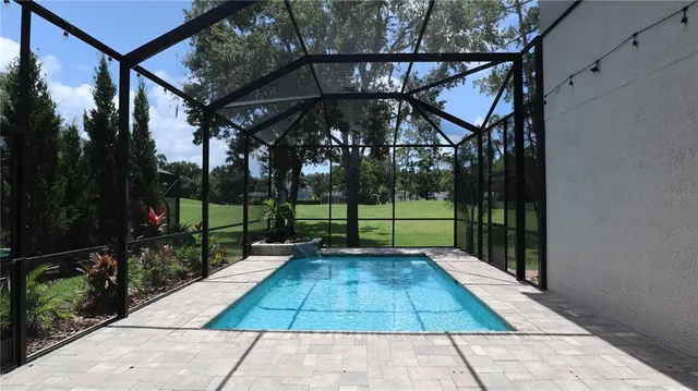a view of a kitchen with wooden floor electronic appliances and windows