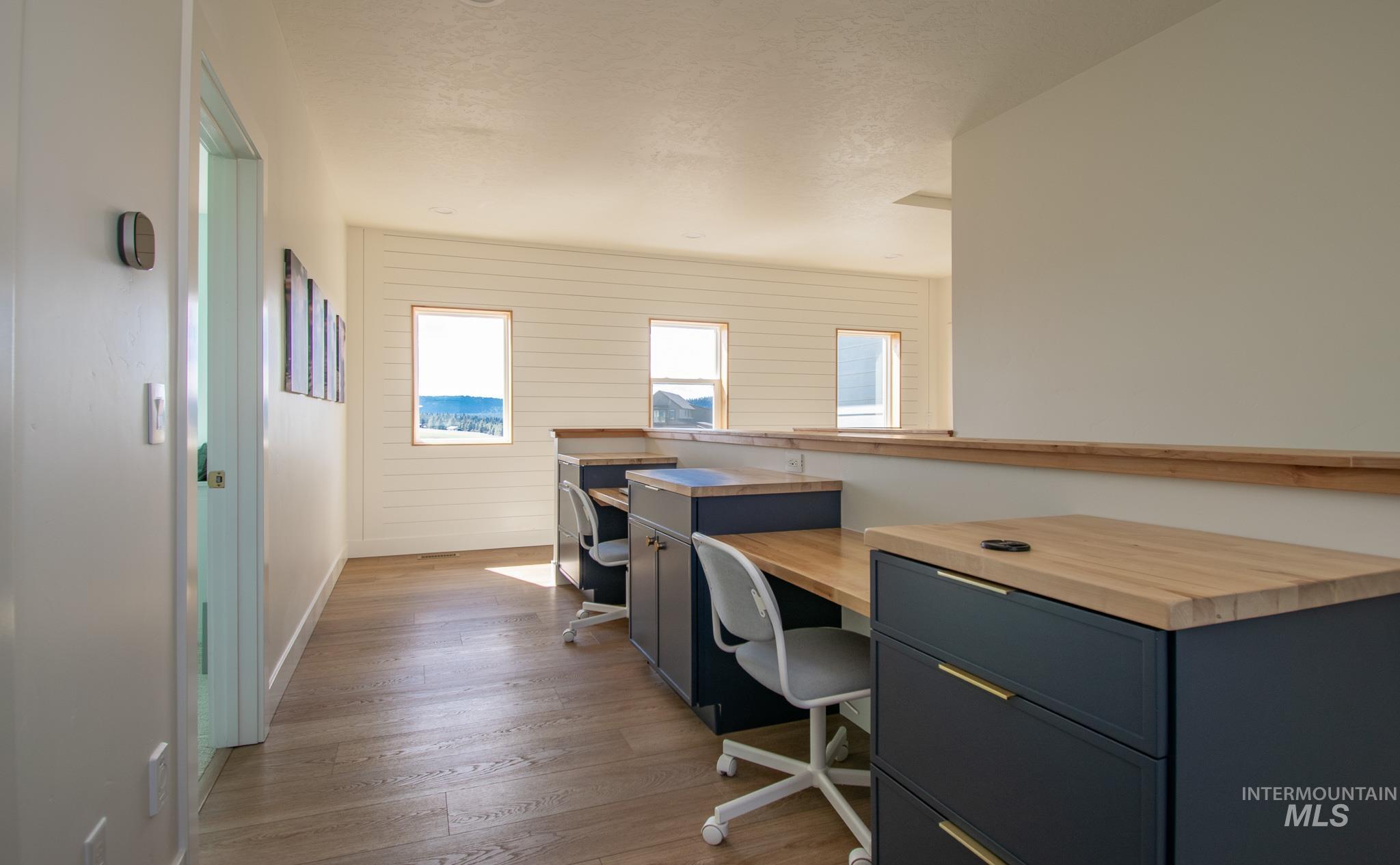 44 Big Moose Road McCall, ID 83638 - Photo 24 of 50 Dedicated workspace featuring built-in desks with wood-finish countertops and dark cabinetry