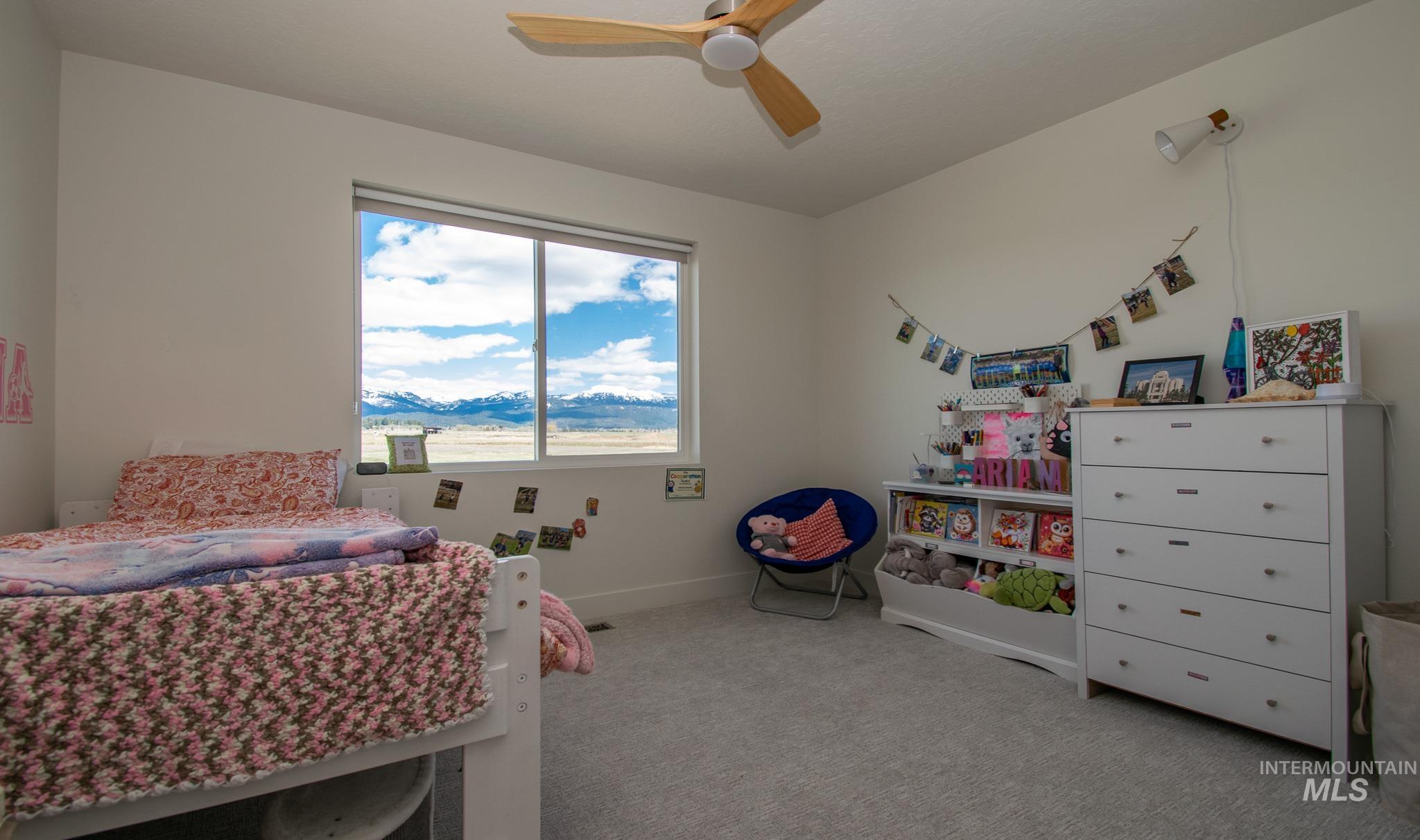 44 Big Moose Road McCall, ID 83638 - Photo 25 of 50 Bright interior space featuring a large window, light gray carpeting, and white walls