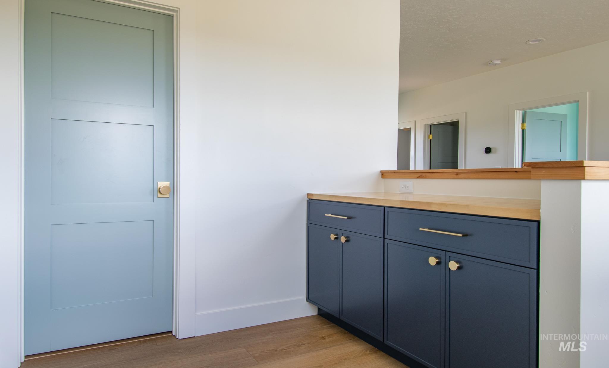 44 Big Moose Road McCall, ID 83638 - Photo 28 of 50 Built-in cabinetry featuring a wood-finish countertop and matte blue shaker-style doors with brass hardware