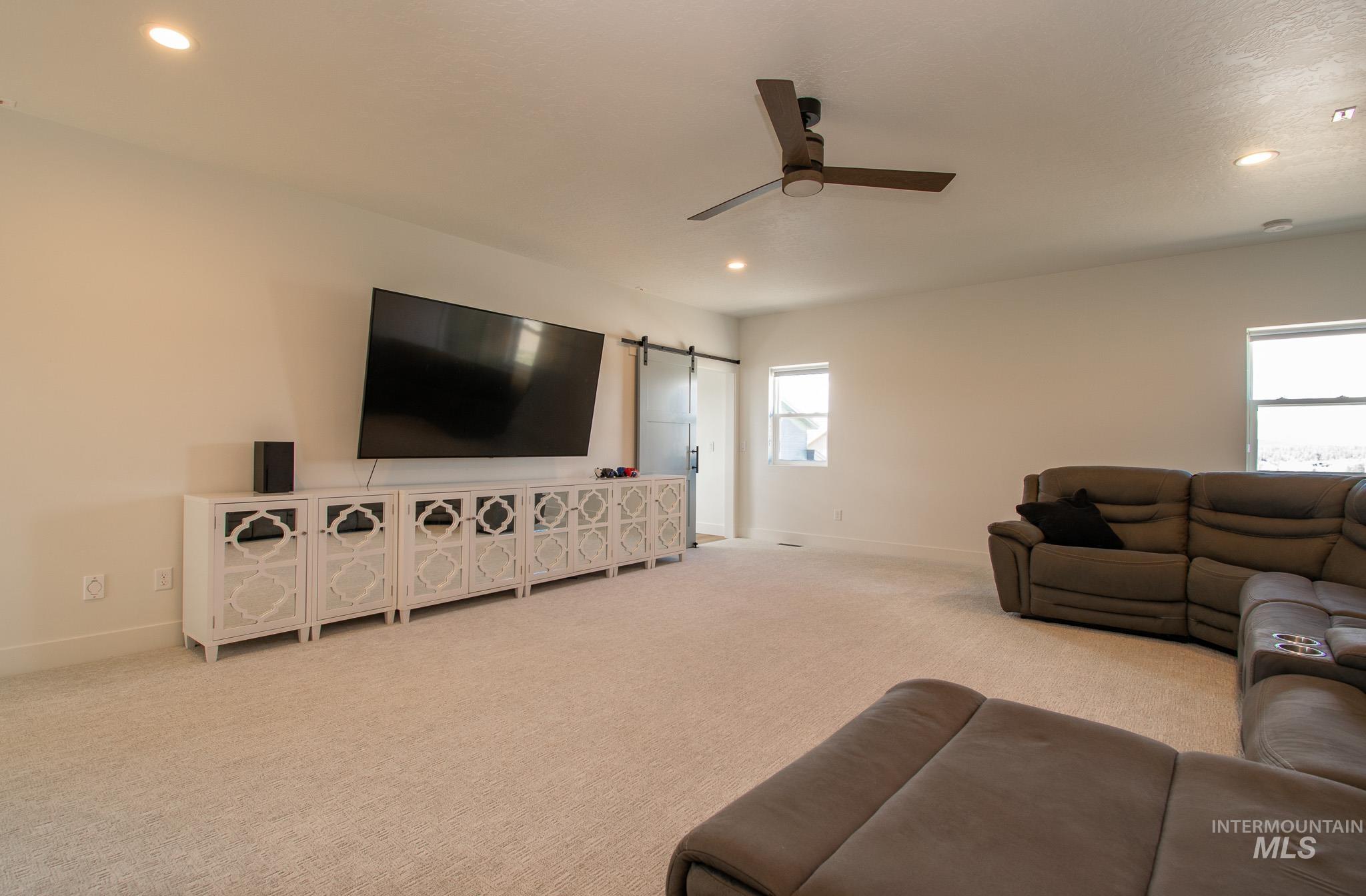 44 Big Moose Road McCall, ID 83638 - Photo 31 of 50 Spacious entertainment room featuring recessed lighting, a ceiling fan, and carpet flooring
