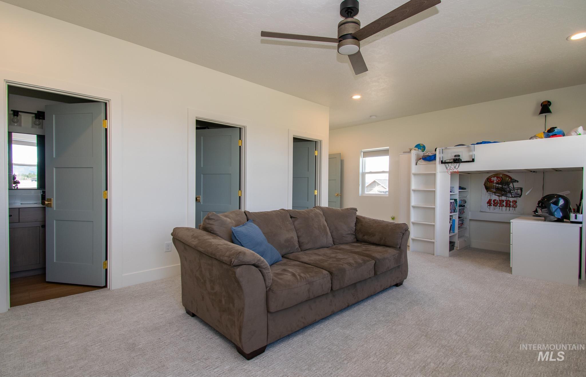 44 Big Moose Road McCall, ID 83638 - Photo 35 of 50 Plush carpeted room featuring a ceiling fan with integrated lighting, three paneled interior doors, and a built-in loft structure with shelving
