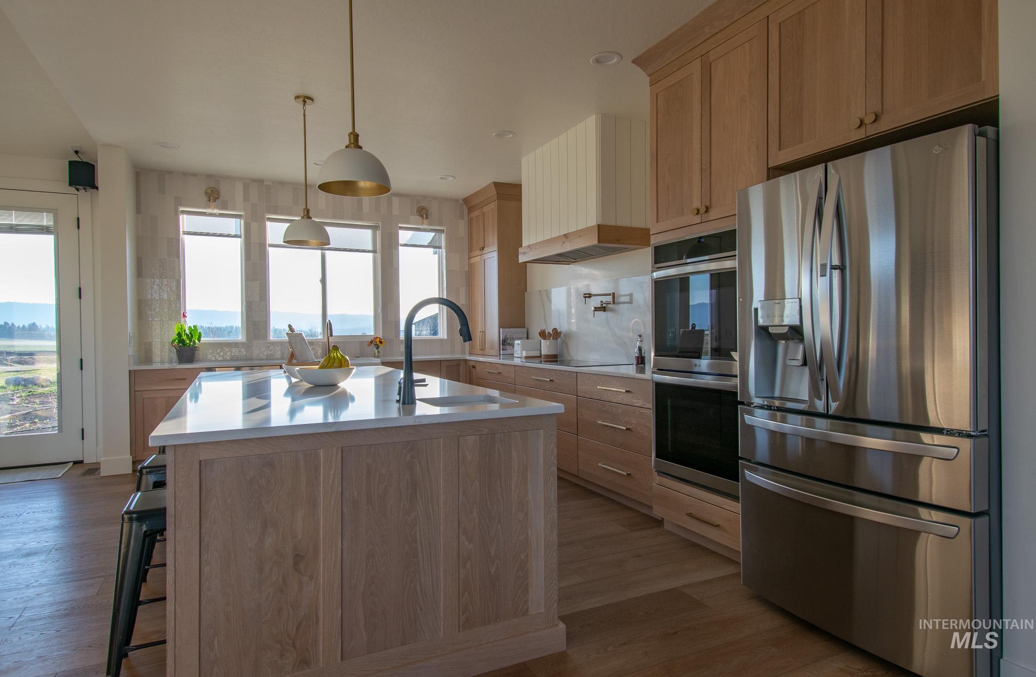 44 Big Moose Road McCall, ID 83638 - Photo 7 of 50 Kitchen island with a white countertop and a black gooseneck faucet