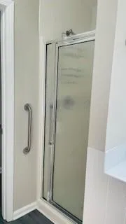 a bathroom with a glass shower door