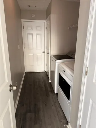 a view of washer and dryer with wooden floor