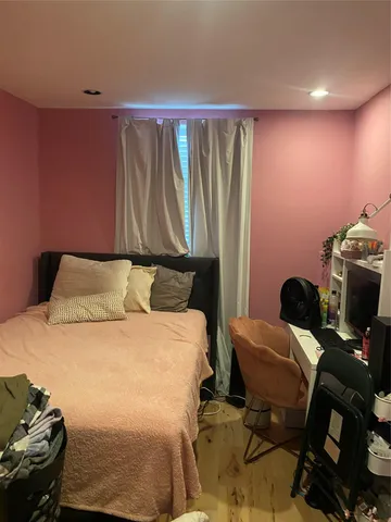 a bedroom with a bed and a chair