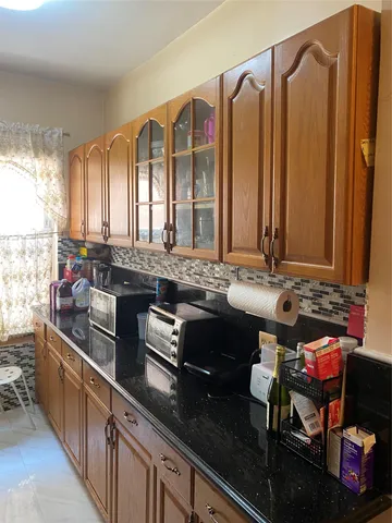 a kitchen with stainless steel appliances granite countertop a sink and a counter
