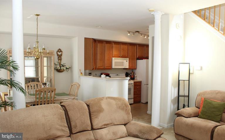 9878 Dochart Sound Lane Bristow, VA 20136 - Photo 11 of 30 a living room with furniture a ceiling fan and a window