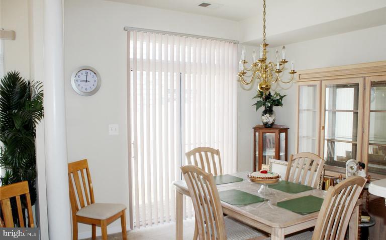 9878 Dochart Sound Lane Bristow, VA 20136 - Photo 13 of 30 a view of a dining room with furniture window and outside view