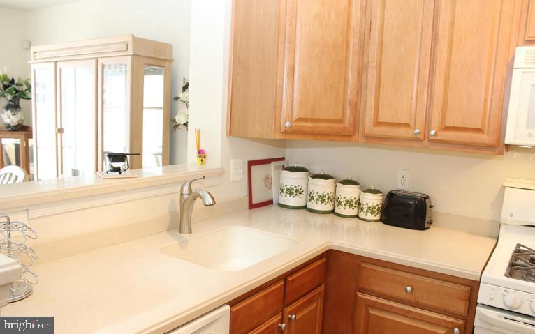 9878 Dochart Sound Lane Bristow, VA 20136 - Photo 17 of 30 a kitchen with a sink and cabinets