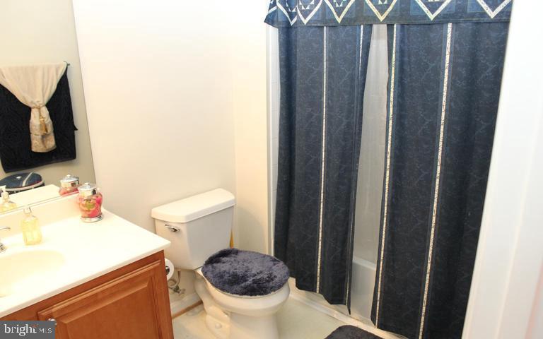 9878 Dochart Sound Lane Bristow, VA 20136 - Photo 21 of 30 a bathroom with a sink toilet and shower