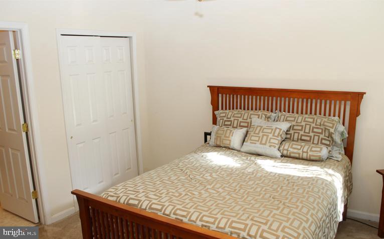 9878 Dochart Sound Lane Bristow, VA 20136 - Photo 23 of 30 a bedroom with a bed and wooden floor