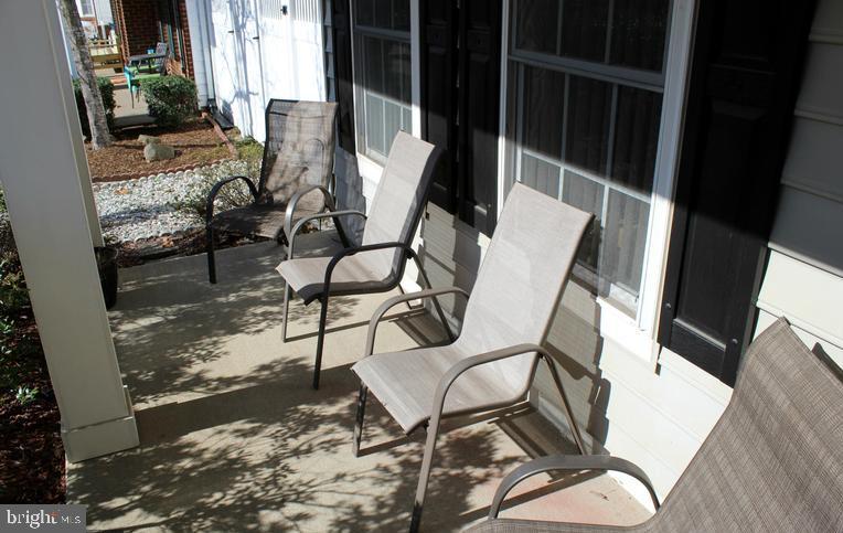 9878 Dochart Sound Lane Bristow, VA 20136 - Photo 6 of 30 a view of a chairs and table in backyard