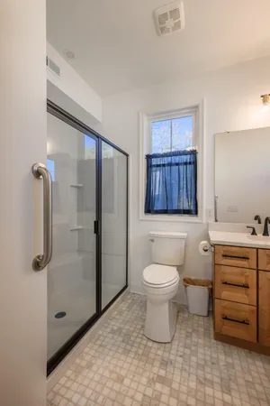 a bathroom with a toilet a sink and shower