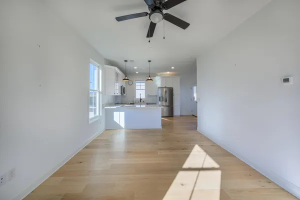 a view of a kitchen with a sink and cabinets