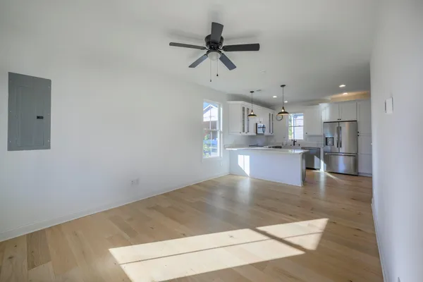 a view of kitchen with a refrigerator a microwave and a stove