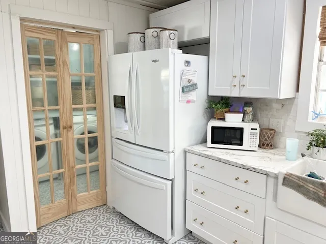 a white refrigerator freezer and a stove sitting inside of a kitchen