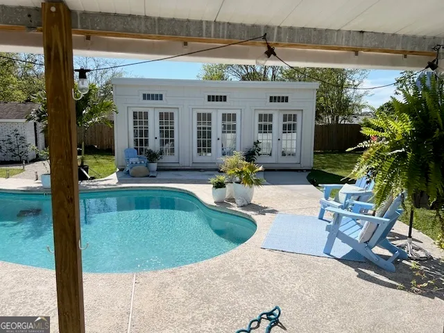 a view of a house with swimming pool and sitting area