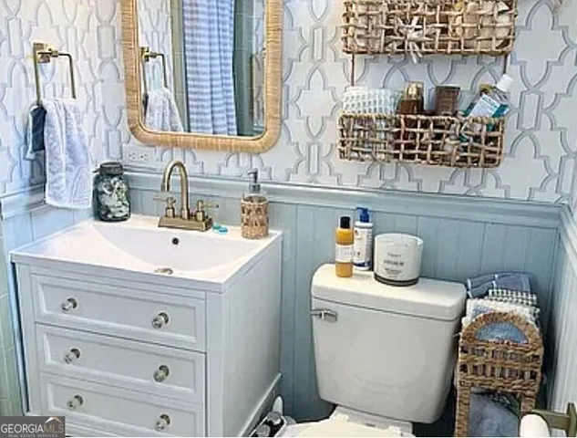 a bathroom with a sink toilet and mirror