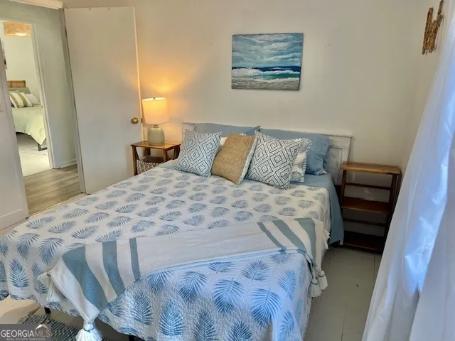 a bedroom with a bed and a walk in closet