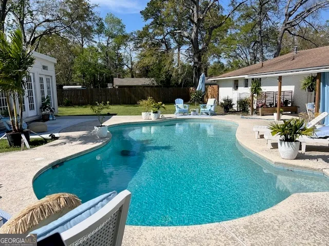 a view of a house with swimming pool and sitting area
